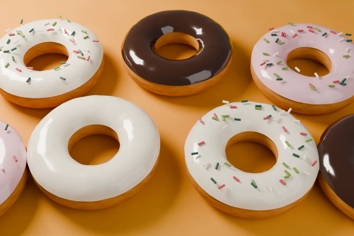 Glazed doughnuts with sprinkles on a saffron-coloured counter