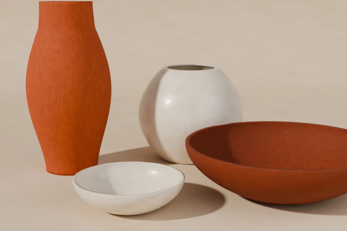 Four handmade pots — a tall terracotta vase, a cream glazed jar and two bowls — on a sand backdrop in warm side light